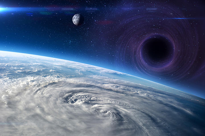 地球と月に接近するブラックホールのイメージ