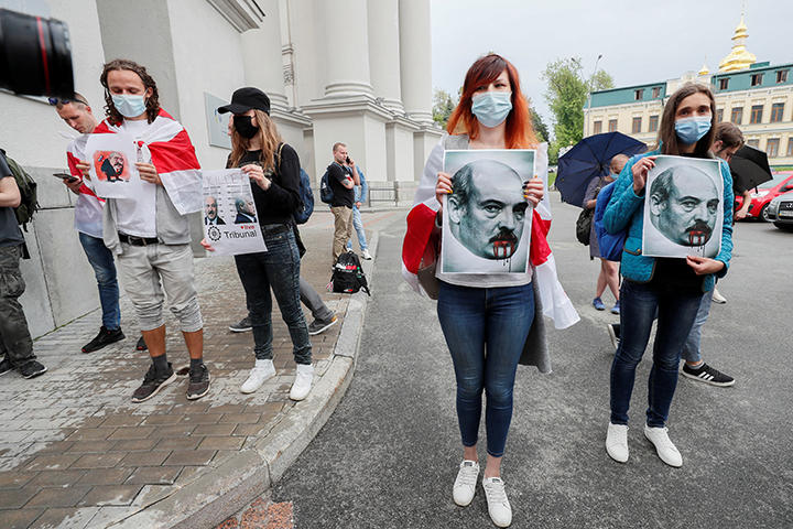 ベラルーシの独裁者ルカシェンコ大統領の肖像を掲げて弾圧に抗議する若者