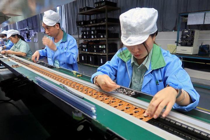 ゲーム機コントローラーを製造する中国・東莞の工場の女性従業員