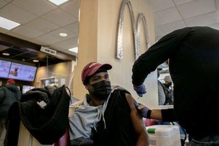シカゴのマクドナルド店内ワクチンの追加接種を受ける男性