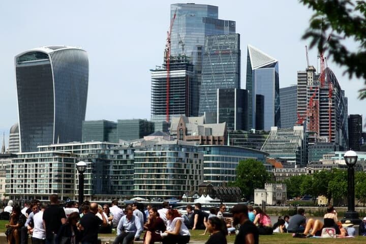 ロンドンの金融街の公園でくつろぐ人々